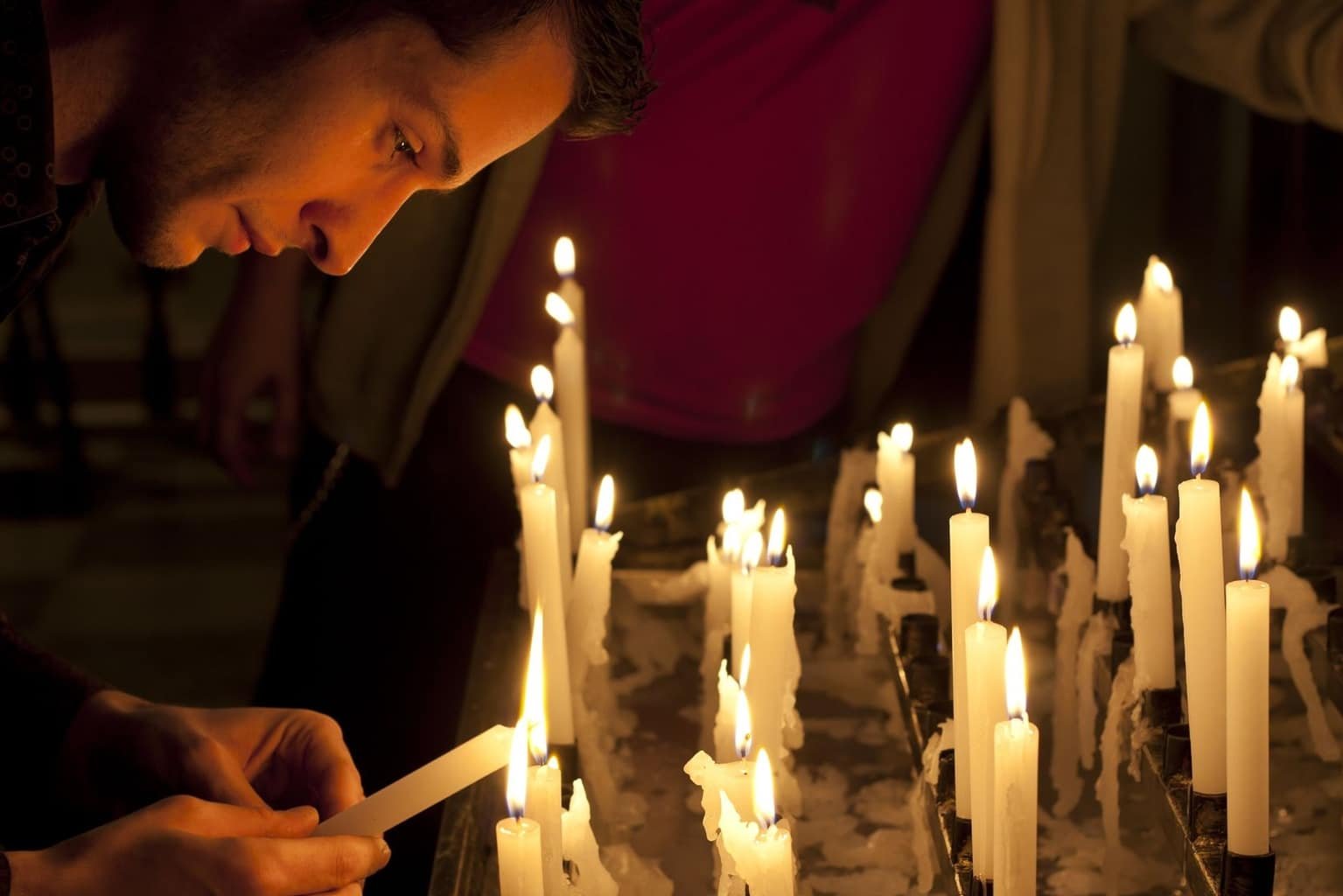 Свечи перед операцией. Мужчина молится в храме. Человек свеча храм. Люди с свечами в церкви. Человек со свечкой.